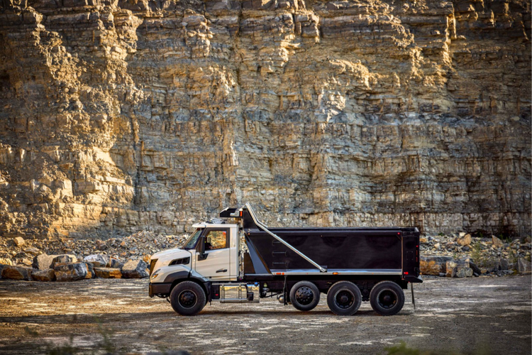 A side view of the Volvo VNX with a rocky background