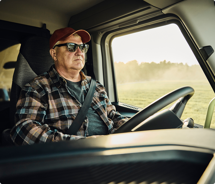 A driver behind the wheel of the Volvo VNX. Using the Volvo Dynamic Steering to effortless drive.
