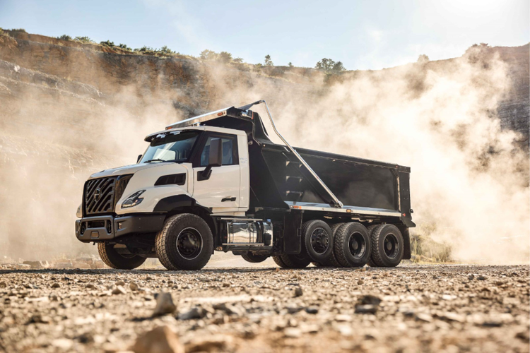 A side view of the Volvo VNX on a rocky background with a smoky background