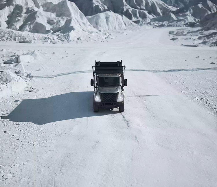 A Volvo VNX with snow in the background.
