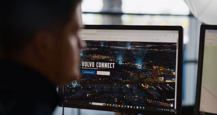 A man looking at the Volvo Connect page on the Volvo website.